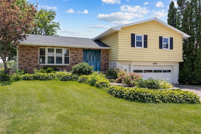 105 Parkview Dr, Tipton, IA 52772 - split level home with brick siding, a garage, a front yard, and driveway