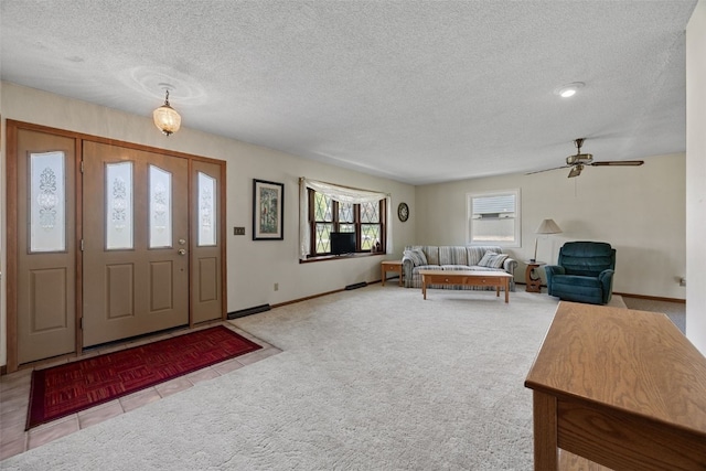 105 Parkview Dr, Tipton, IA 52772 - entrance foyer featuring a textured ceiling, carpet floors, a ceiling fan, and tile patterned flooring