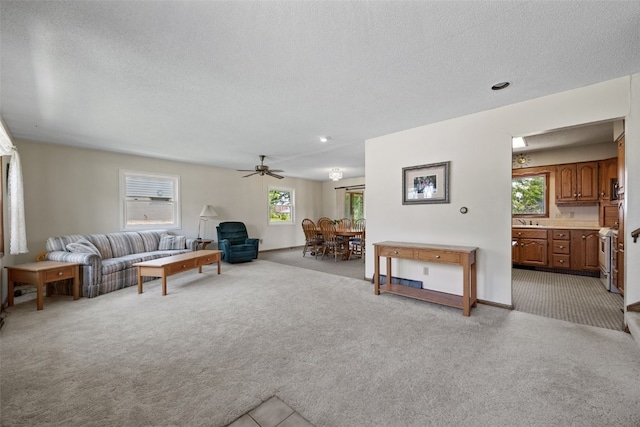 105 Parkview Dr, Tipton, IA 52772 - living area with light colored carpet, a textured ceiling, and ceiling fan