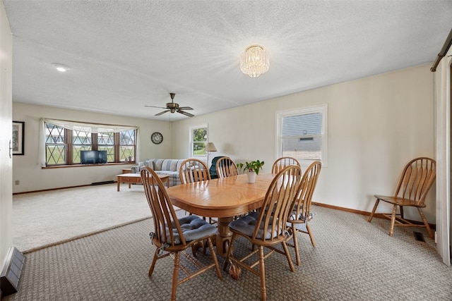 105 Parkview Dr, Tipton, IA 52772 - dining room featuring carpet floors, a ceiling fan, and a textured ceiling