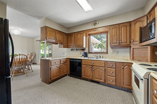 105 Parkview Dr, Tipton, IA 52772 - kitchen with black appliances, brown cabinetry, healthy amount of natural light, and a textured ceiling