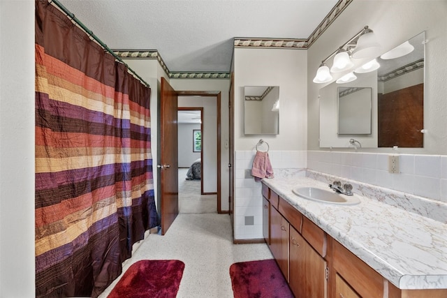 105 Parkview Dr, Tipton, IA 52772 - full bathroom with vanity, wainscoting, a textured ceiling, and curtained shower