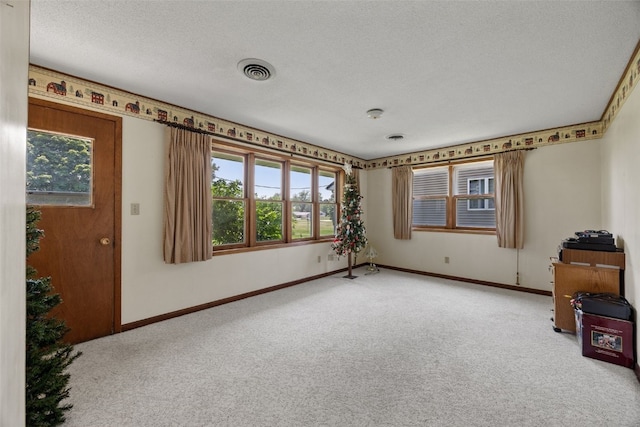 105 Parkview Dr, Tipton, IA 52772 - unfurnished room featuring carpet floors, plenty of natural light, and a textured ceiling