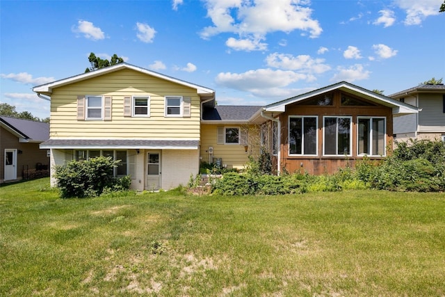105 Parkview Dr, Tipton, IA 52772 - rear view of property with a lawn and brick siding