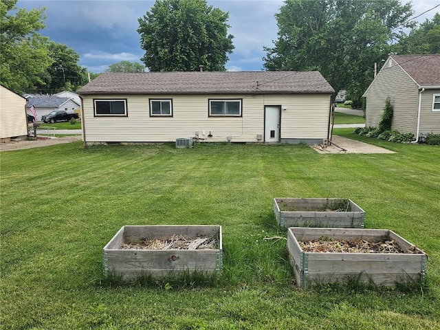 1523 Golden Valley Dr, Bettendorf, IA 52722 - rear view of property with a vegetable garden and a yard