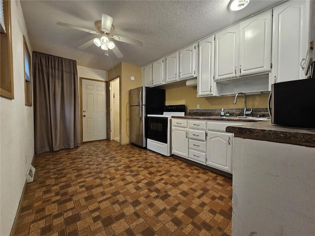 1523 Golden Valley Dr, Bettendorf, IA 52722 - kitchen with dark countertops, freestanding refrigerator, range with electric stovetop, white cabinetry, and ceiling fan
