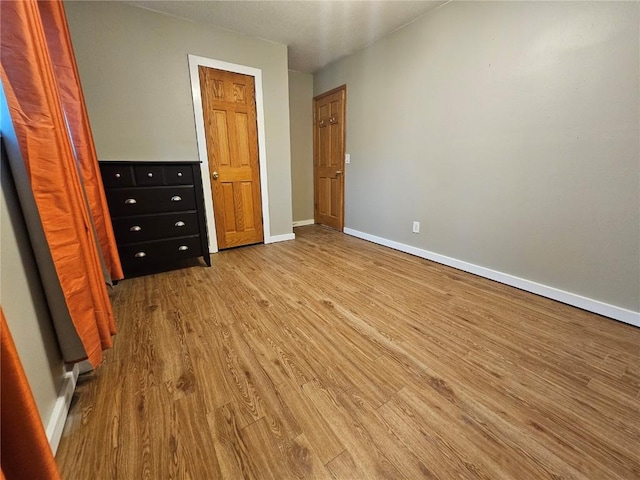 1523 Golden Valley Dr, Bettendorf, IA 52722 - unfurnished bedroom featuring wood finished floors and baseboards