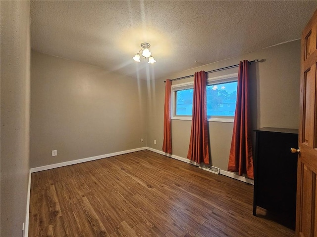 1523 Golden Valley Dr, Bettendorf, IA 52722 - unfurnished room featuring dark wood-style floors and a textured ceiling