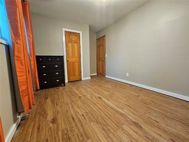 1523 Golden Valley Dr, Bettendorf, IA 52722 - unfurnished bedroom featuring wood finished floors and baseboards
