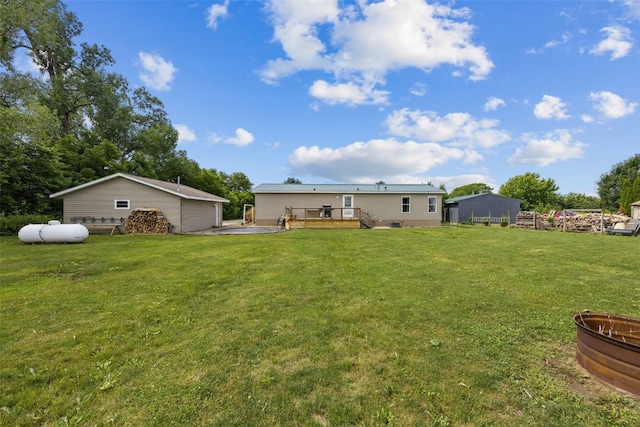 3017 118th St, Amana, IA 52203 - view of green lawn featuring a wooden deck and an outdoor structure