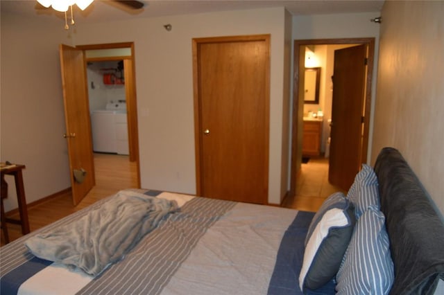 454 W Side Dr, Iowa City, IA 52245 - bedroom with washing machine and clothes dryer, a closet, wood finished floors, and ceiling fan