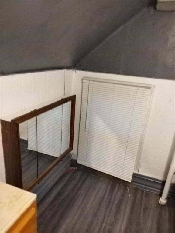 1402 N St SW, Cedar Rapids, IA 52404 - additional living space with dark wood-type flooring and vaulted ceiling