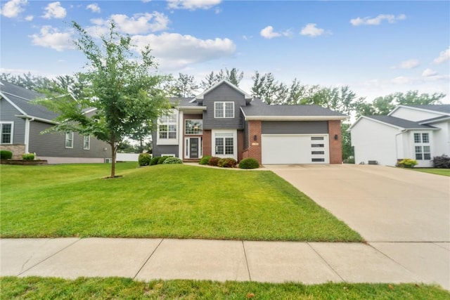 2385 Wolf Creek Trl, Hiawatha, IA 52233 - tri-level home featuring concrete driveway, a front yard, brick siding, and a garage