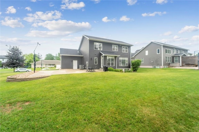 2385 Wolf Creek Trl, Hiawatha, IA 52233 - rear view of property featuring a yard, concrete driveway, and a patio