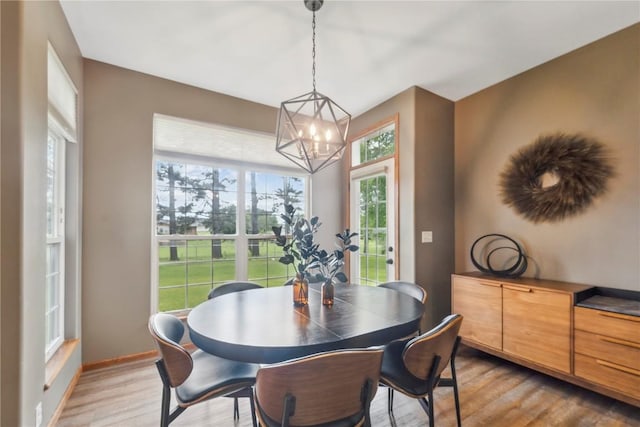 2385 Wolf Creek Trl, Hiawatha, IA 52233 - dining room featuring light wood-type flooring and a chandelier