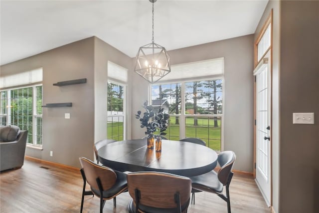 2385 Wolf Creek Trl, Hiawatha, IA 52233 - dining room featuring a chandelier and light wood-type flooring