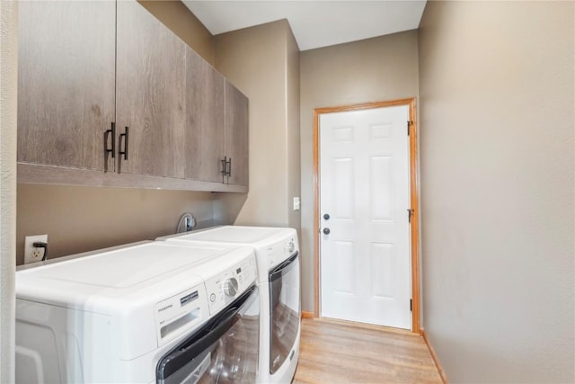 2385 Wolf Creek Trl, Hiawatha, IA 52233 - laundry area with cabinet space, washing machine and dryer, and light wood finished floors