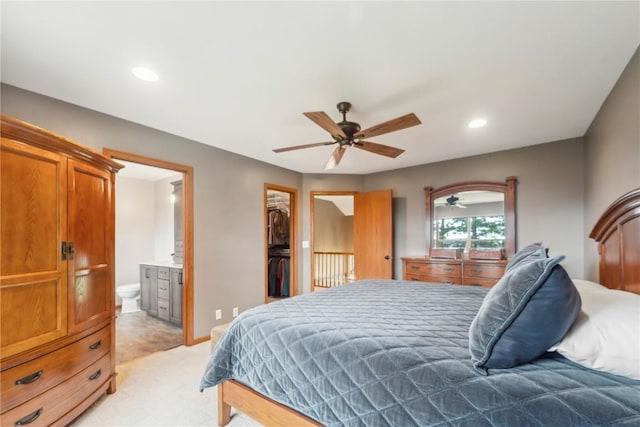 2385 Wolf Creek Trl, Hiawatha, IA 52233 - bedroom featuring light colored carpet, connected bathroom, a walk in closet, recessed lighting, and a closet