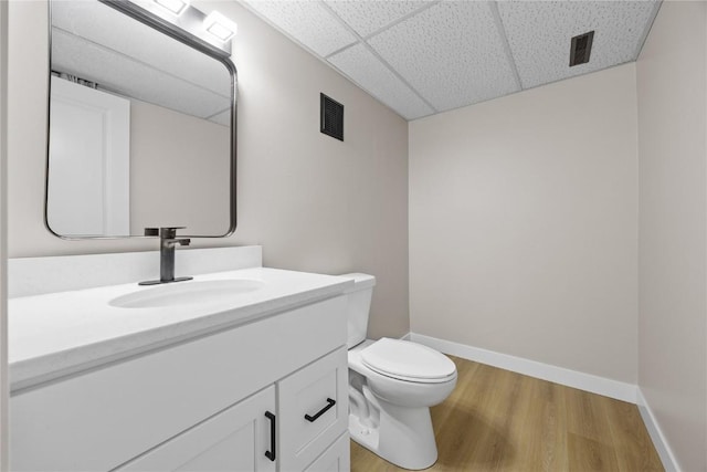 6612 Boulder Dr, Cedar Rapids, IA 52405 - bathroom with a drop ceiling, vanity, and wood finished floors