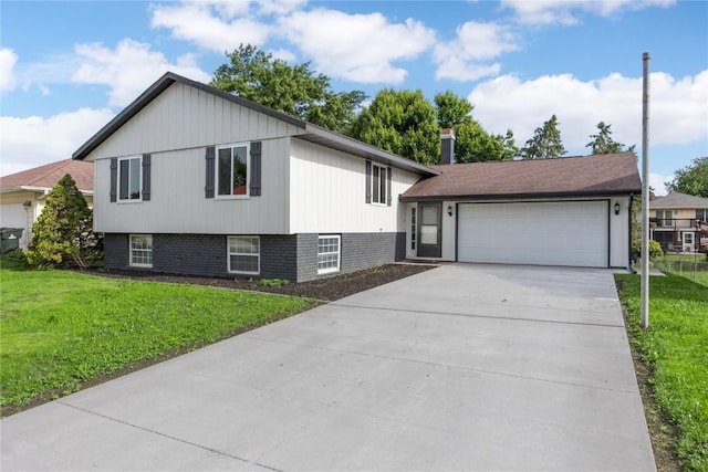 6612 Boulder Dr, Cedar Rapids, IA 52405 - split level home with driveway, a front yard, a garage, and brick siding