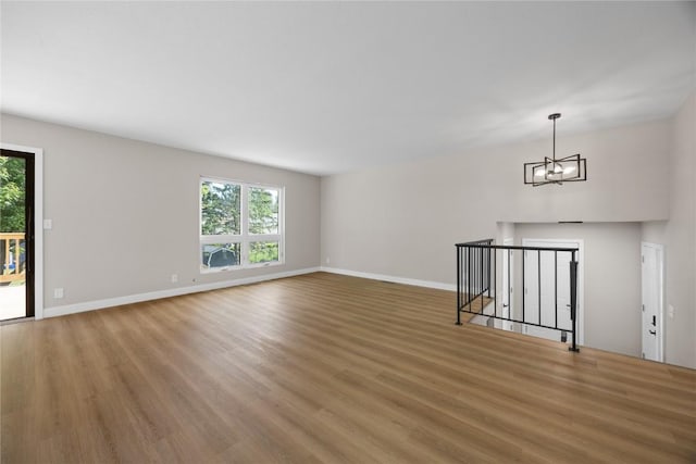 6612 Boulder Dr, Cedar Rapids, IA 52405 - empty room featuring healthy amount of natural light, a chandelier, and light wood-style floors