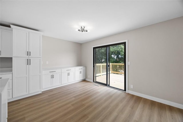 6612 Boulder Dr, Cedar Rapids, IA 52405 - unfurnished dining area featuring light wood-style floors and baseboards
