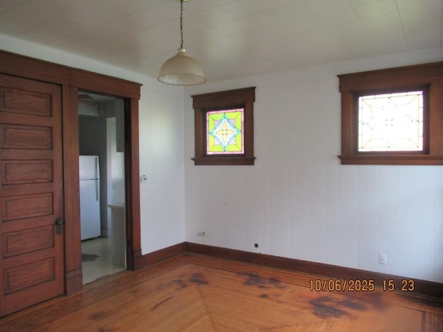 606 Meridian St, Tipton, IA 52772 - unfurnished room featuring baseboards and wood finished floors