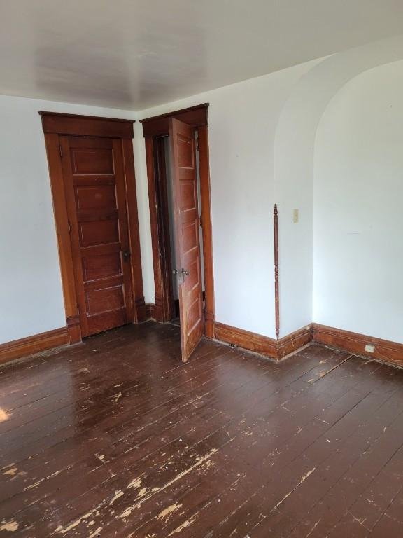 606 Meridian St, Tipton, IA 52772 - unfurnished room featuring wood-type flooring and arched walkways