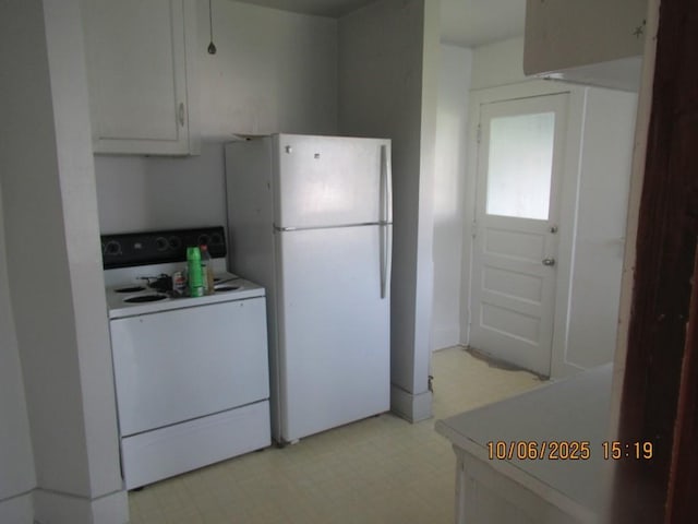 606 Meridian St, Tipton, IA 52772 - kitchen with white appliances, light floors, light countertops, and white cabinetry