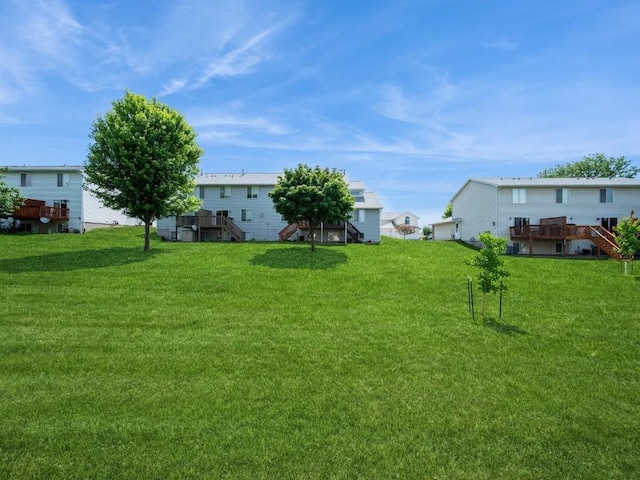 2635 6th St, Marion, IA 52302 - view of grassy yard with stairway and a wooden deck