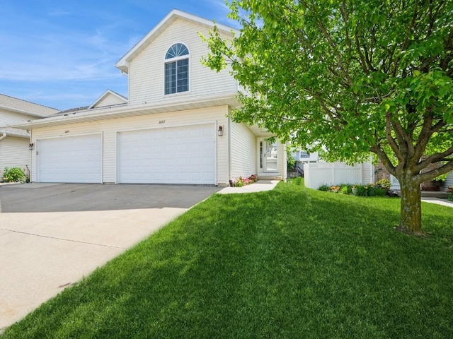 2635 6th St, Marion, IA 52302 - view of front of house with concrete driveway, a front lawn, and an attached garage