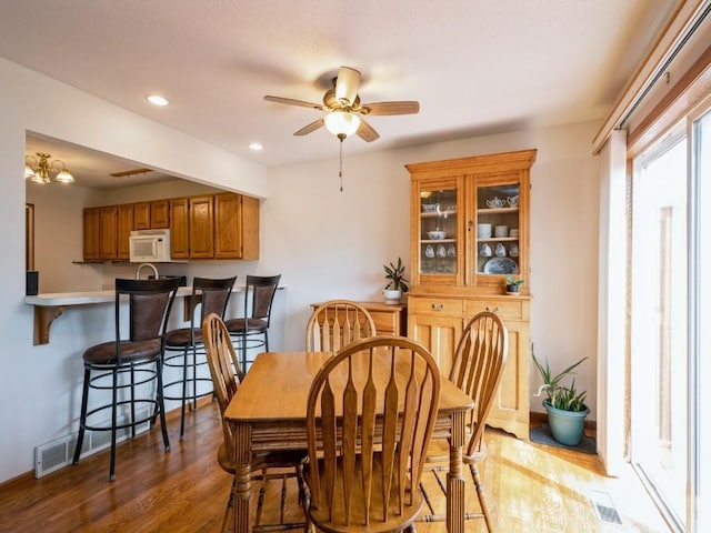 2635 6th St, Marion, IA 52302 - dining room featuring wood finished floors, a ceiling fan, and recessed lighting