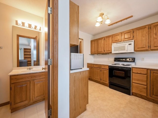 2635 6th St, Marion, IA 52302 - kitchen featuring white microwave, range with electric cooktop, brown cabinets, light countertops, and a chandelier
