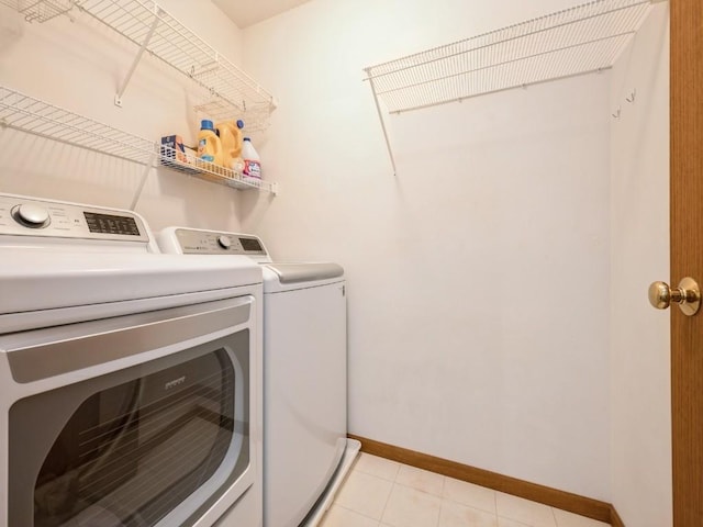 2635 6th St, Marion, IA 52302 - laundry area with washing machine and clothes dryer and light tile patterned floors