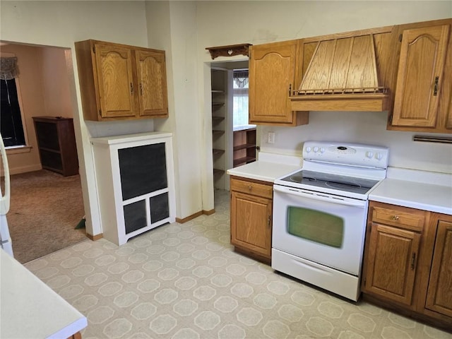 708 E 4th St, Vinton, IA 52349 - kitchen with white range with electric cooktop, custom range hood, and brown cabinetry