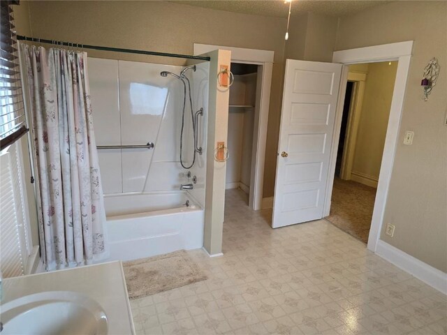 708 E 4th St, Vinton, IA 52349 - bathroom featuring shower / bath combo with shower curtain, tile patterned floors, and vanity