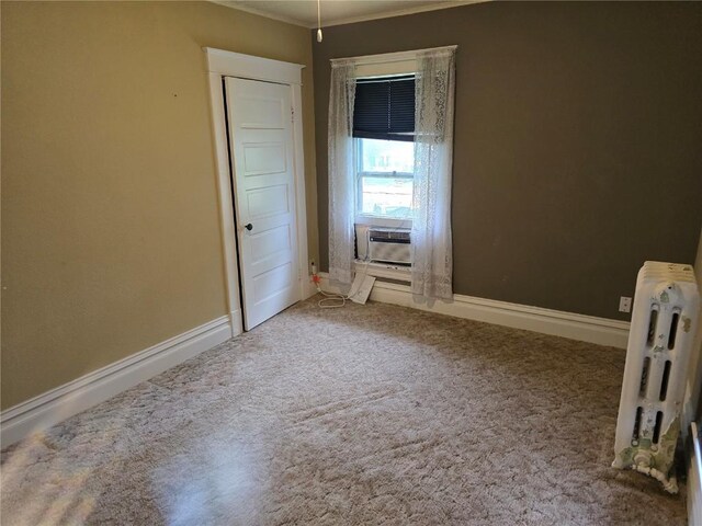 708 E 4th St, Vinton, IA 52349 - unfurnished bedroom with cooling unit, radiator heating unit, carpet, and ornamental molding