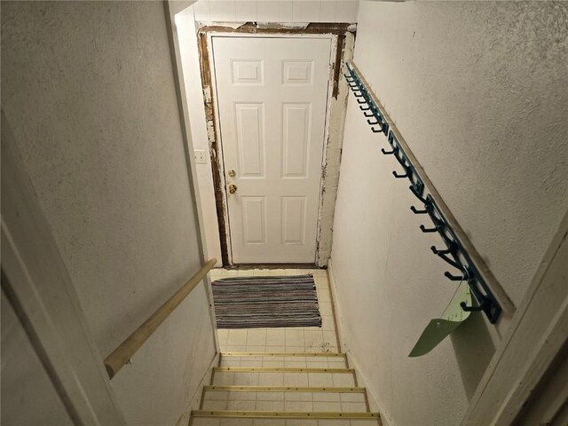 708 E 4th St, Vinton, IA 52349 - stairs featuring a textured wall and baseboards