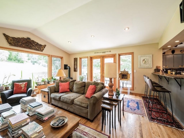 4288 Fox Meadow Dr SE, Cedar Rapids, IA 52403 - living area featuring plenty of natural light, light wood-type flooring, vaulted ceiling, recessed lighting, and a wood stove