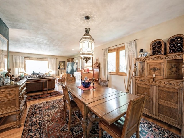 4288 Fox Meadow Dr SE, Cedar Rapids, IA 52403 - dining space featuring light wood finished floors, plenty of natural light, and a chandelier