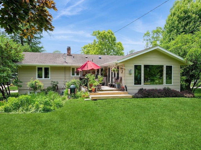 4288 Fox Meadow Dr SE, Cedar Rapids, IA 52403 - rear view of house featuring a chimney, a lawn, a wooden deck, and a shingled roof