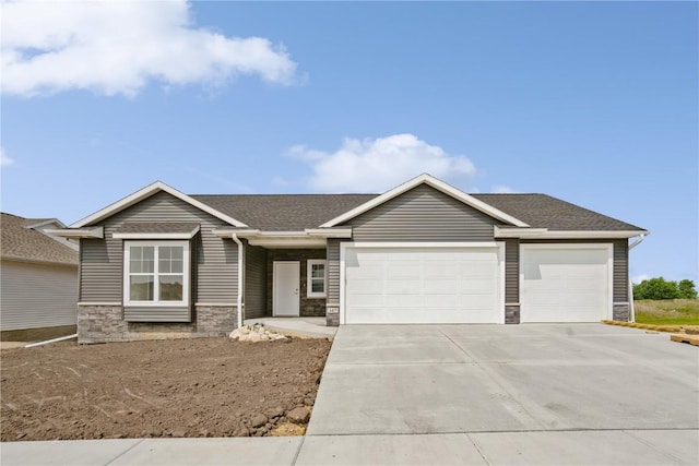 1417 Echo Ridge Ln, Marion, IA 52302 - view of front of home with an attached garage, driveway, stone siding, and a shingled roof