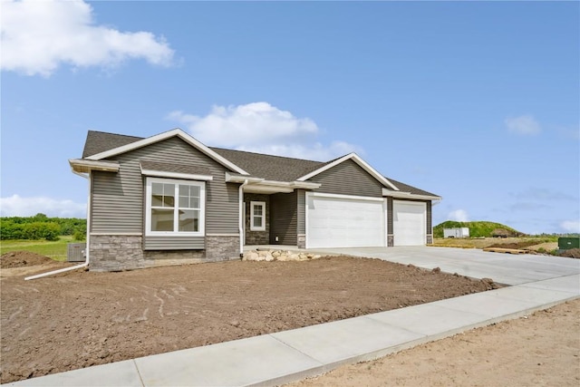 1417 Echo Ridge Ln, Marion, IA 52302 - view of front of house with driveway, an attached garage, stone siding, and roof with shingles