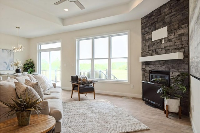 1417 Echo Ridge Ln, Marion, IA 52302 - living area featuring healthy amount of natural light, ceiling fan, a raised ceiling, and light wood-style flooring