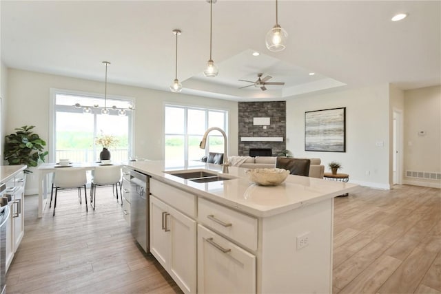 1417 Echo Ridge Ln, Marion, IA 52302 - kitchen with ceiling fan, a fireplace, light wood-type flooring, a raised ceiling, and recessed lighting
