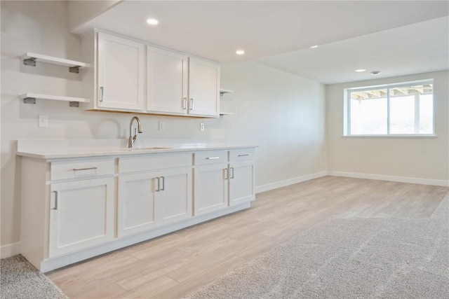 1417 Echo Ridge Ln, Marion, IA 52302 - kitchen featuring open shelves, white cabinets, light countertops, light wood-style floors, and recessed lighting
