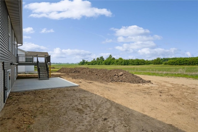 1417 Echo Ridge Ln, Marion, IA 52302 - view of yard with a patio, stairs, a view of countryside, and a deck