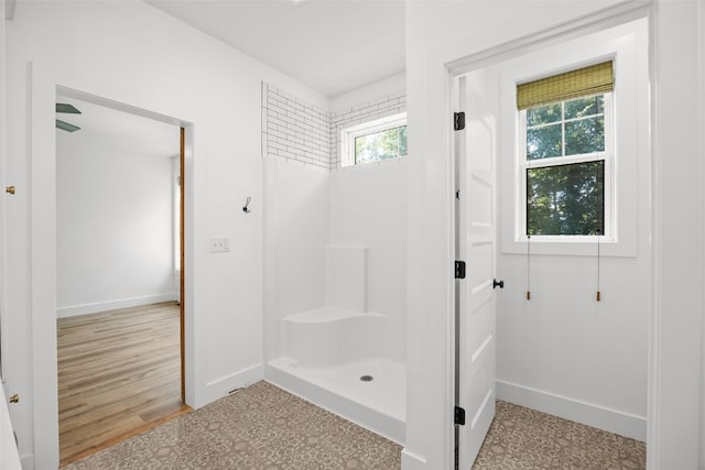 1153 Cedar Springs Dr, Marion, IA 52302 - bathroom featuring a shower and wood finished floors