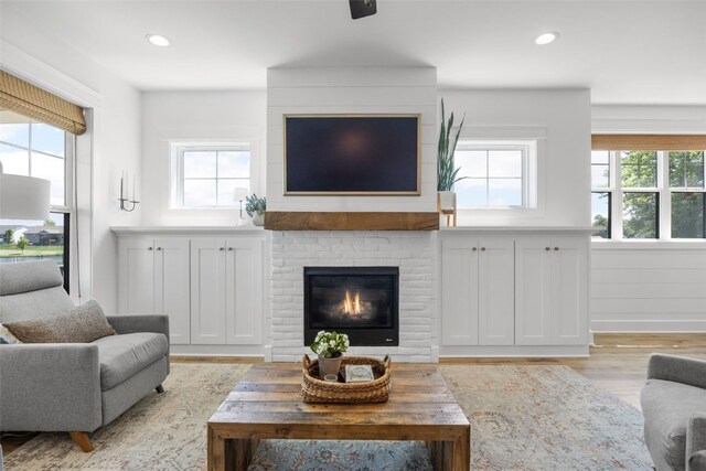 1153 Cedar Springs Dr, Marion, IA 52302 - living room with healthy amount of natural light, light wood-style floors, recessed lighting, and a fireplace