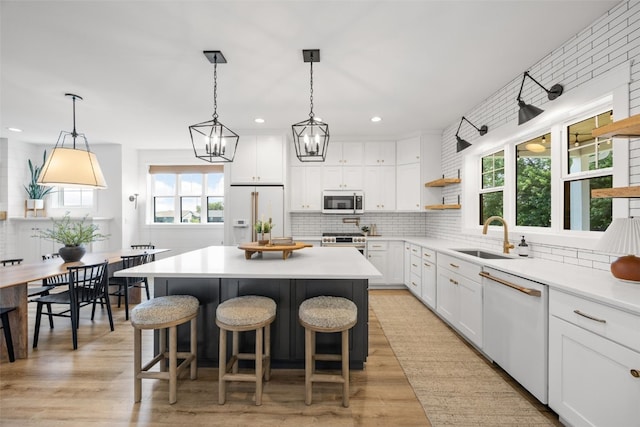 1153 Cedar Springs Dr, Marion, IA 52302 - kitchen with white appliances, open shelves, tasteful backsplash, white cabinetry, and a center island